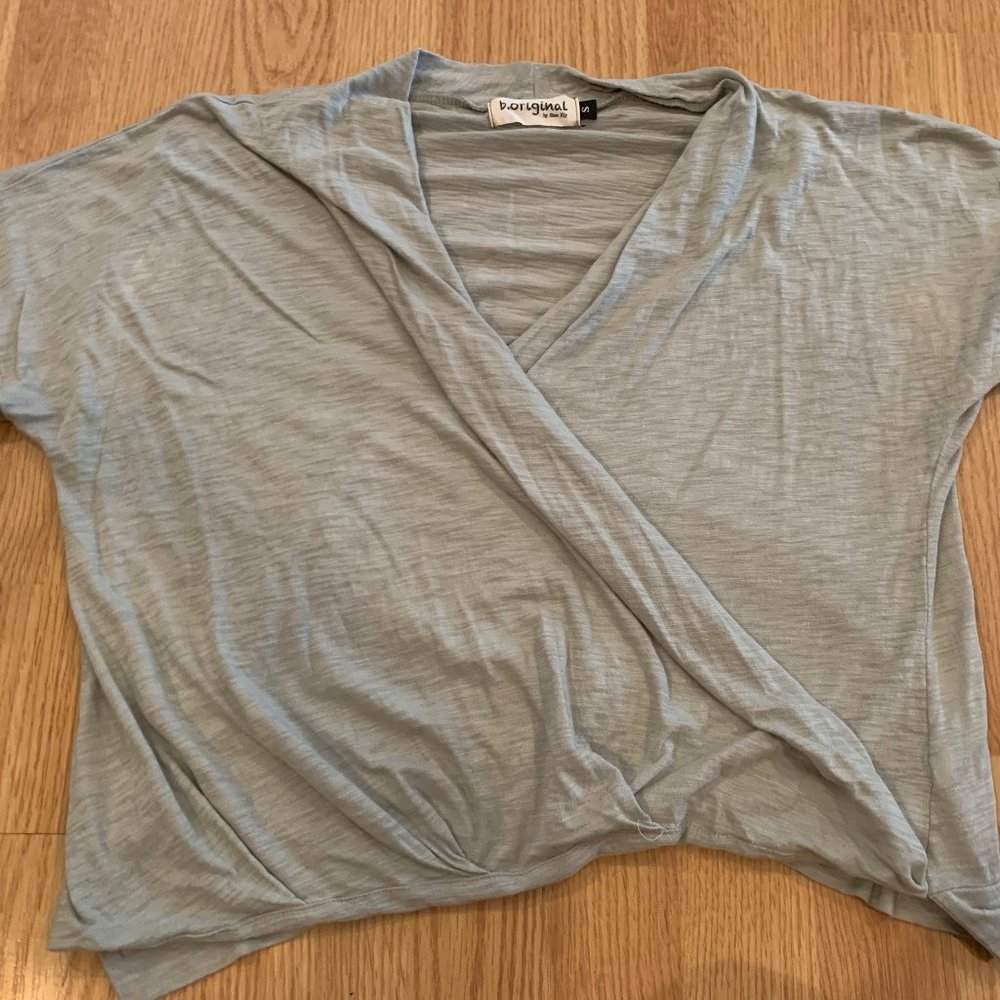 Light green top that criss crosses in the front